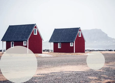 Unterkünfte in Island: 2 rote Hütten mit einem Berg im Hintergrund